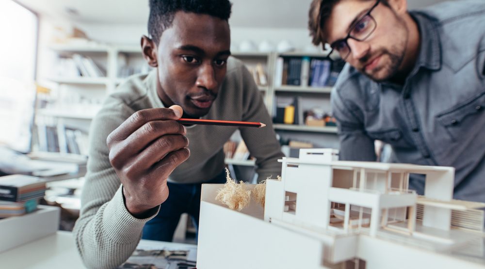 architects choosing a wood floor|Architects looking at a building model